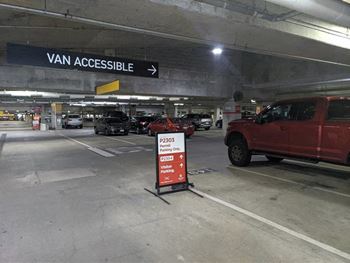 a parking garage with a red truck and a sign at 1305 Dock Street, Baltimore, MD